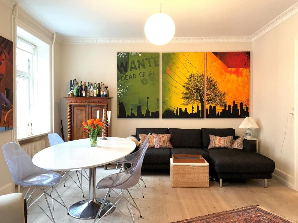 a living room with a couch and a table at ApartmentInCopenhagen Apartment 1436 in Copenhagen