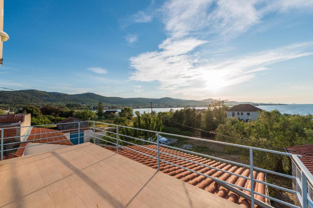 a balcony with a view of the water at Villa Rosa in Pašman