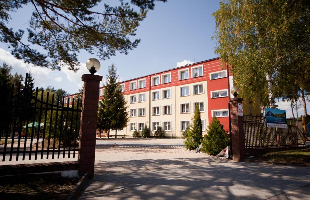 a building with a gate in front of a building at Selment Resort in Ełk
