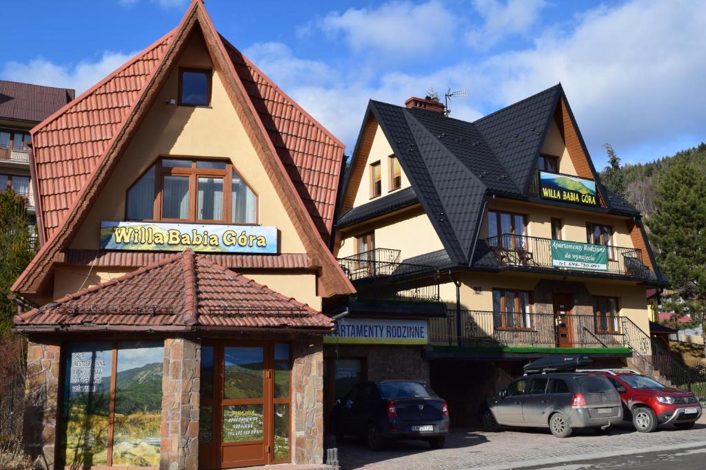 a building with a sign for a mountain bike center at Willa Babia Góra in Zawoja