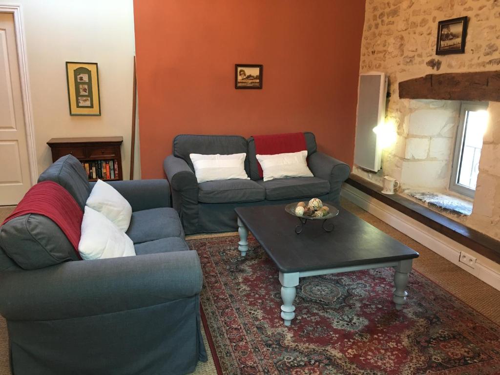 a living room with two couches and a coffee table at Apart d'Arc in Saintes