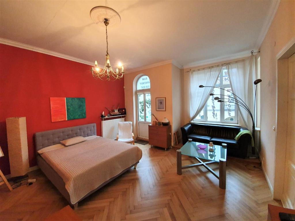 a bedroom with a bed and a piano at Casa Di Pinokio in Sopot