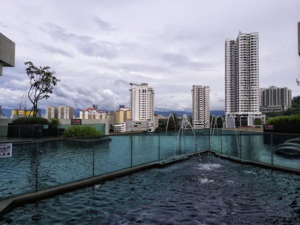 a pool of water with a city in the background at My Artz J.Dupion Duplex Suite @ Cheras in Kuala Lumpur