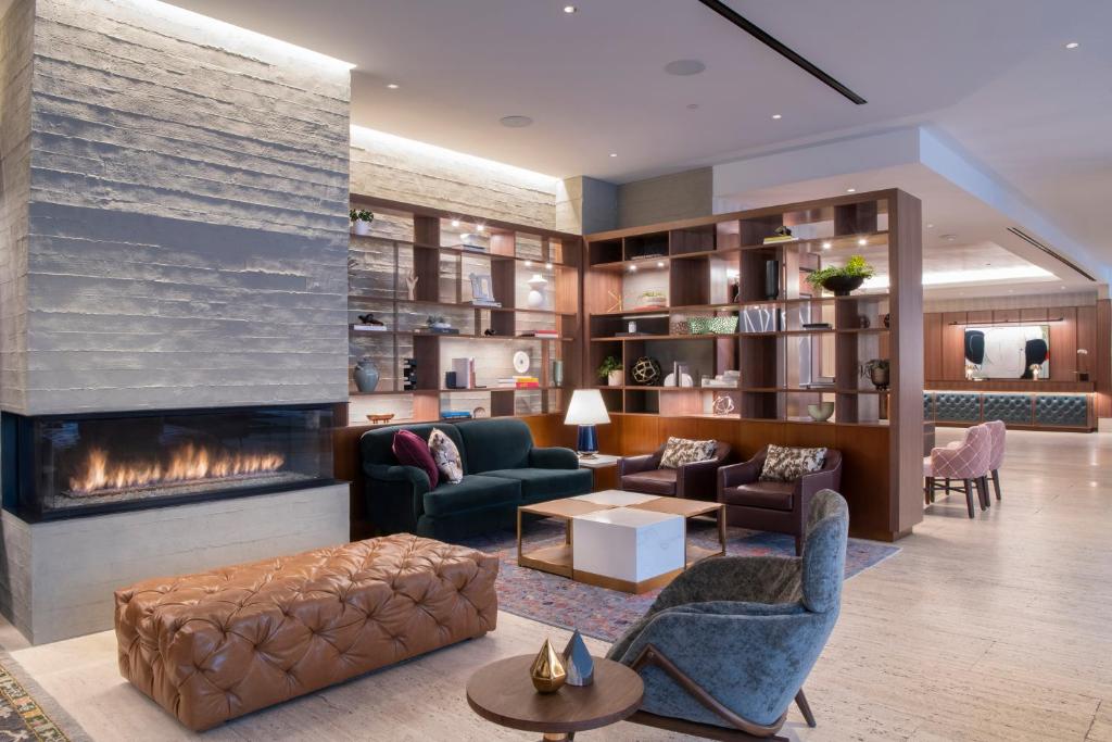 a living room with a fireplace and furniture at The Colonnade Hotel in Boston