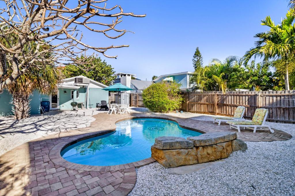 a swimming pool in a yard with a patio and a house at Sea's The Day in Anna Maria