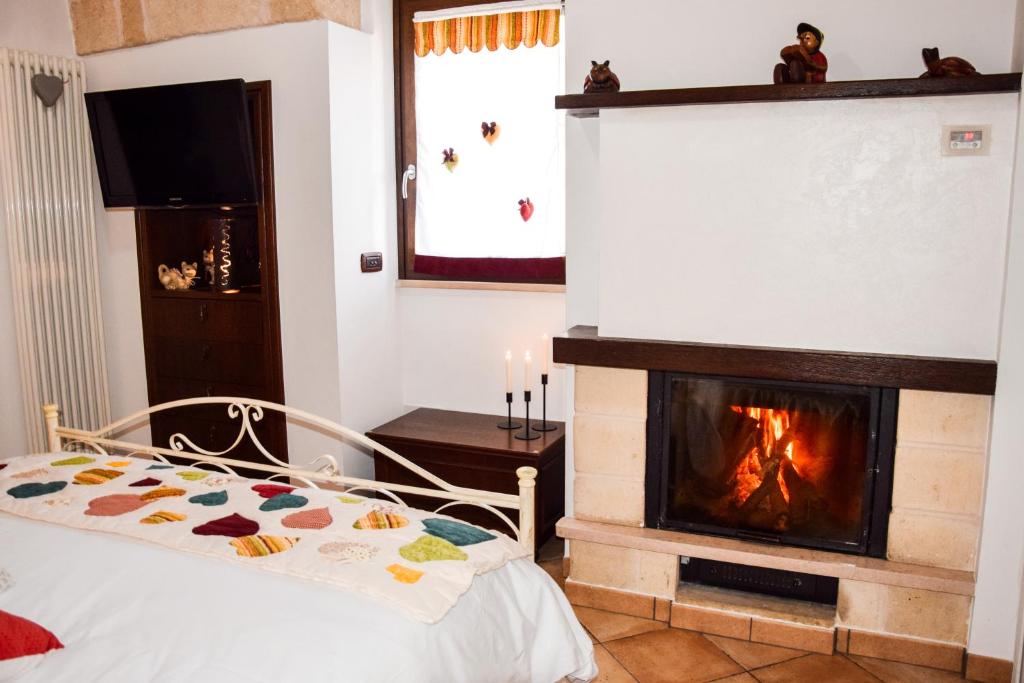 a bedroom with a fireplace and a bed in front of it at Cuorcuoredicasa in Monopoli