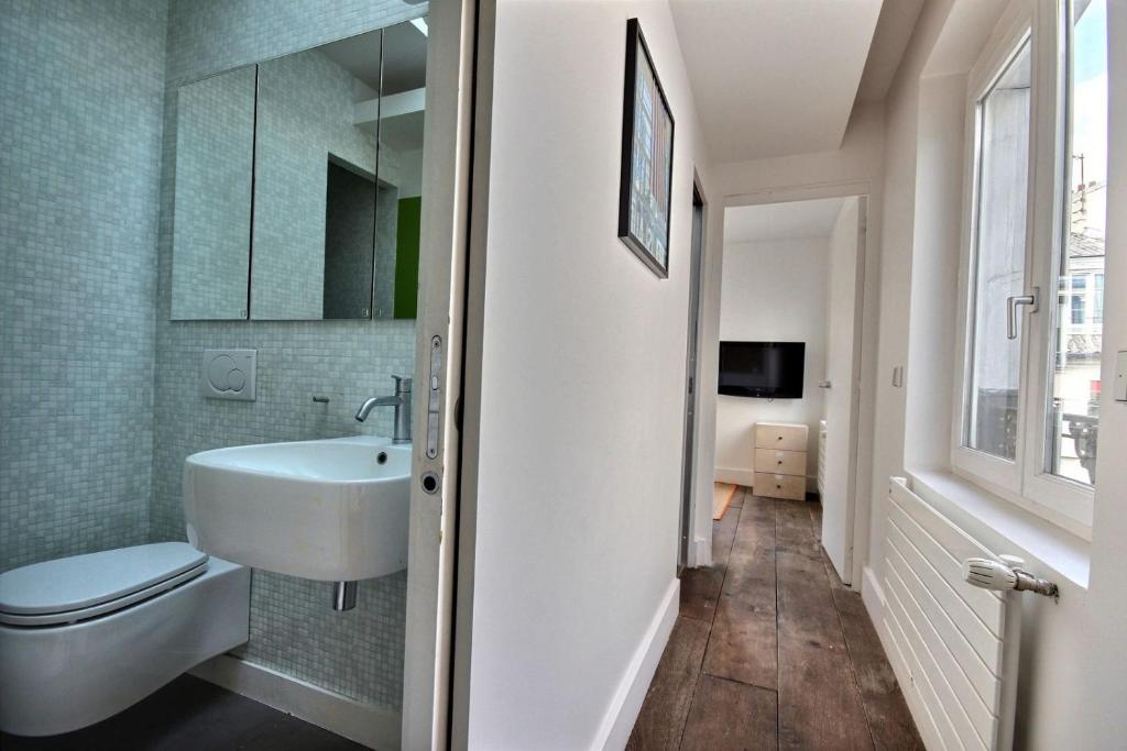 a bathroom with a sink and a toilet at 502254 - Spacious duplex apartment for 12 people near Les Halles in Paris