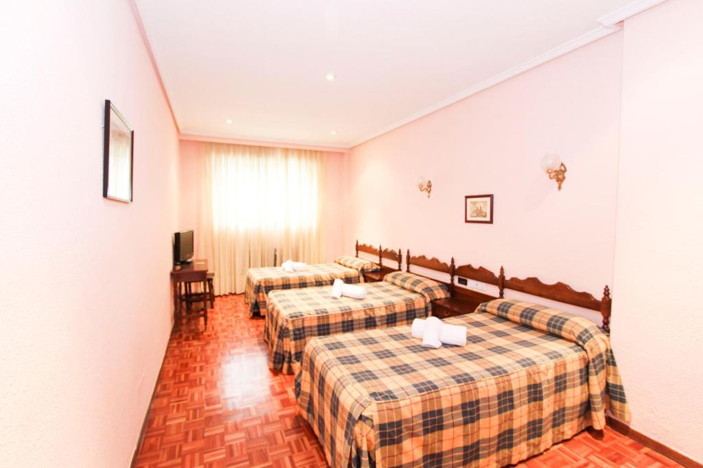 Postel nebo postele na pokoji v ubytování Hotel Castellano Centro