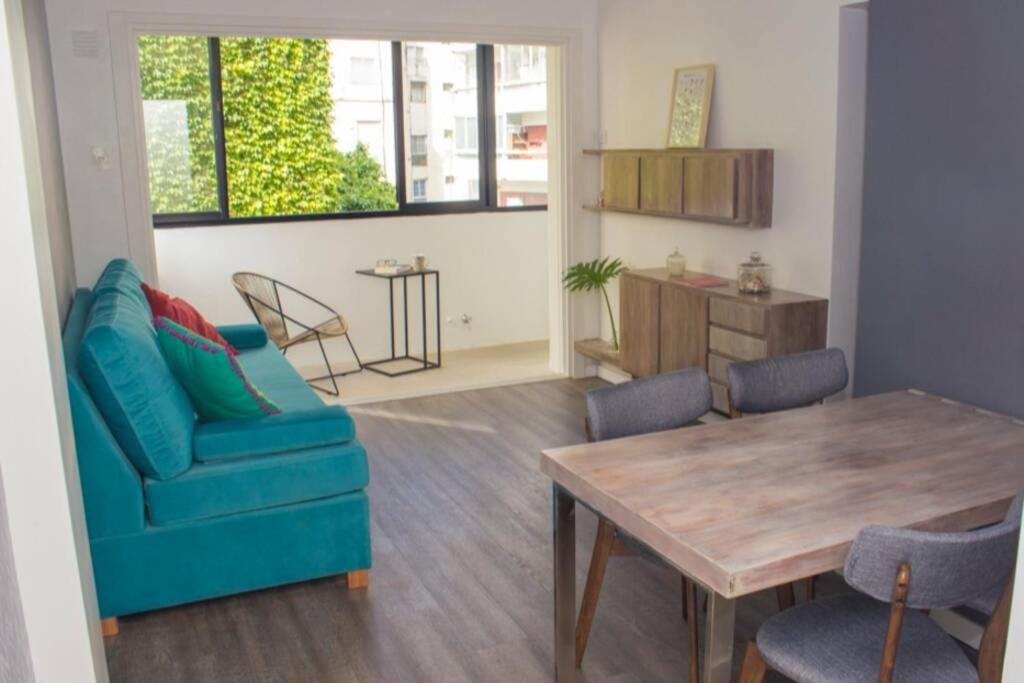 sala de estar con sofá azul y mesa en RecoBerta Apartment. Diseñado para disfrutar en Buenos Aires