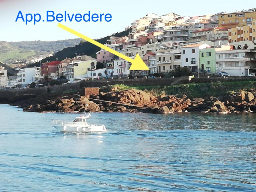 ein weißes Boot im Wasser mit einem gelben Pfeil in der Unterkunft Appartamento Belvedere in Castelsardo