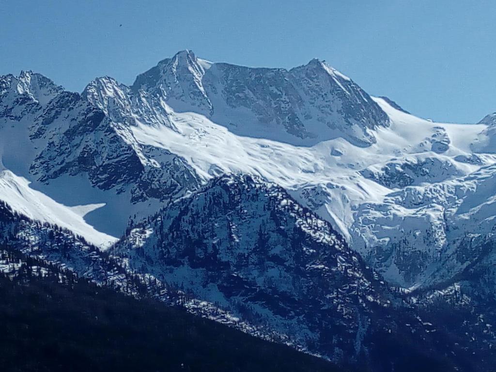 a snow covered mountain range with snow on it at Appartamento Cristallo di Ghiaccio in Passo del Tonale