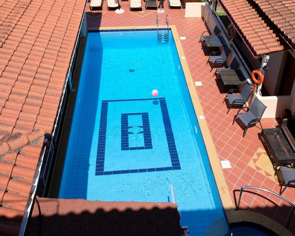 an overhead view of a swimming pool with a ball at Taxiarchis Apartments in Skiathos Town