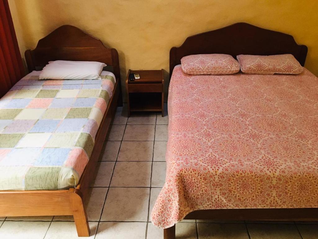 Postel nebo postele na pokoji v ubytování Hotel Casa Esmeralda