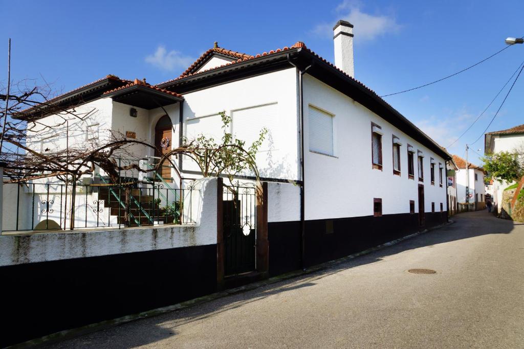 una casa blanca con techo negro en Casa D'Avó Mila, en Góis