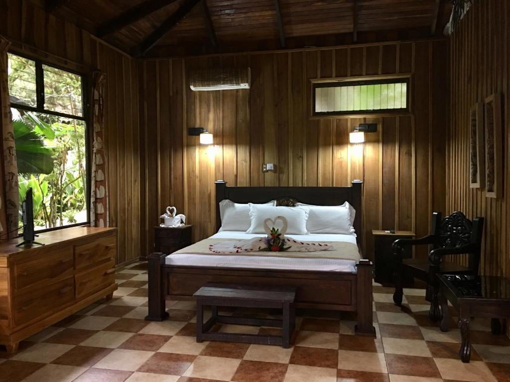 a bedroom with a large bed and a large window at Hotel Kokoro Mineral Hot Springs in Fortuna