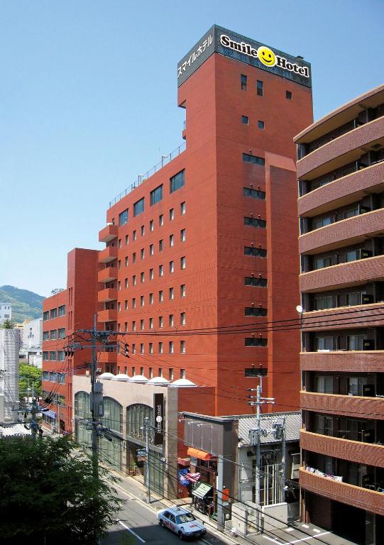 a tall red building with a samsung sign on it at Smile Hotel Sasebo in Sasebo