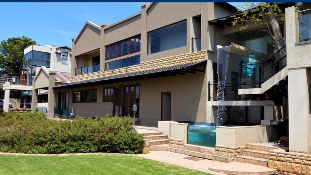 a house with a swimming pool in front of it at inn on mars in Pretoria