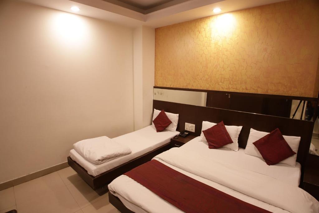 Postel nebo postele na pokoji v ubytování Hotel Golden Wings