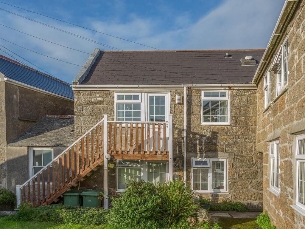 a house with a deck on the side of it at Potters by the Sea in Penzance