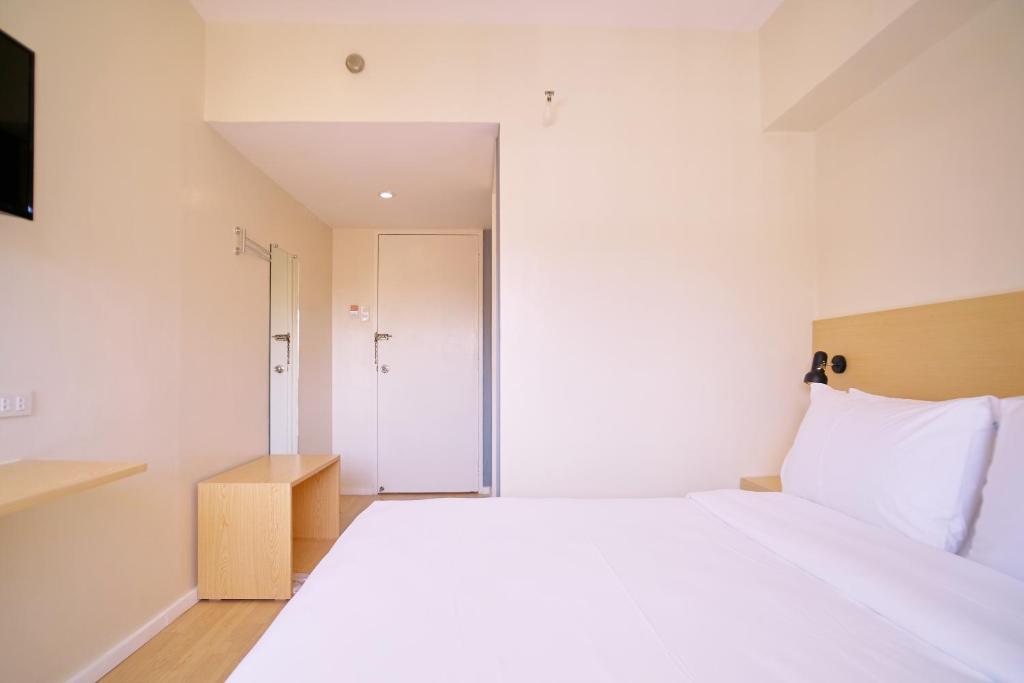 Postel nebo postele na pokoji v ubytování Bridge Hotel Express