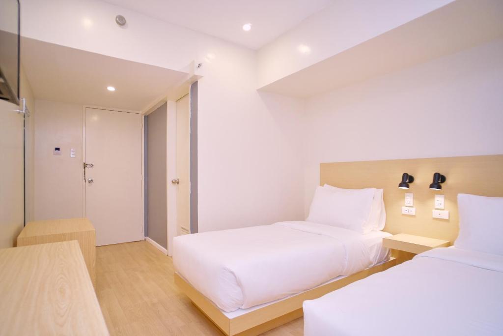 Postel nebo postele na pokoji v ubytování Bridge Hotel Express