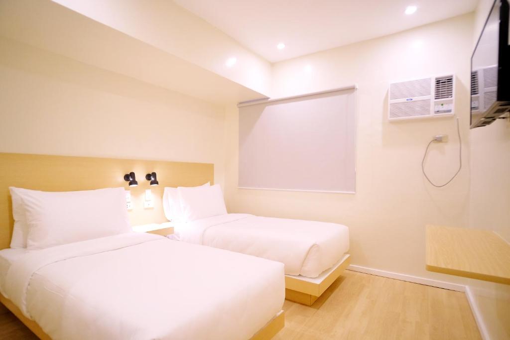 Postel nebo postele na pokoji v ubytování Bridge Hotel Express