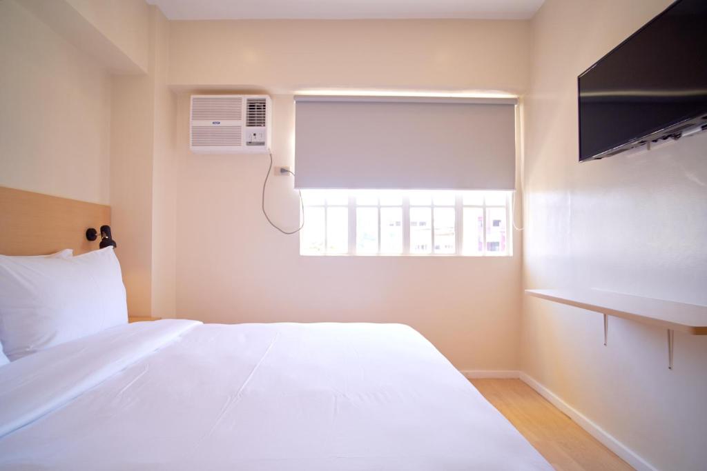 Postel nebo postele na pokoji v ubytování Bridge Hotel Express