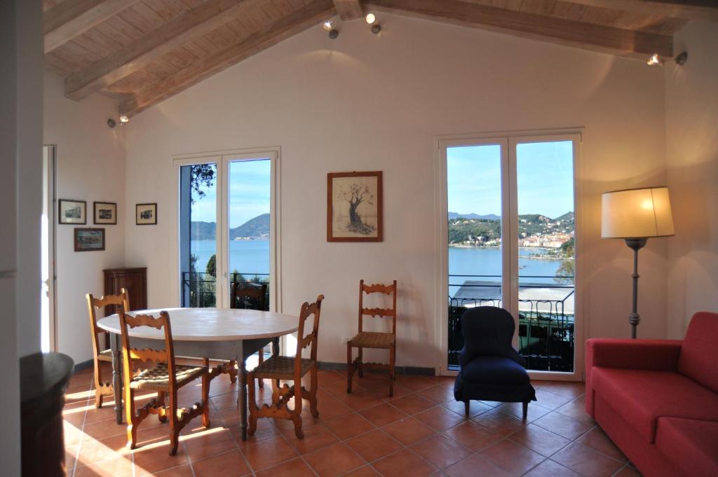 a living room with a table and chairs and a couch at Casetta Gialla in Lerici