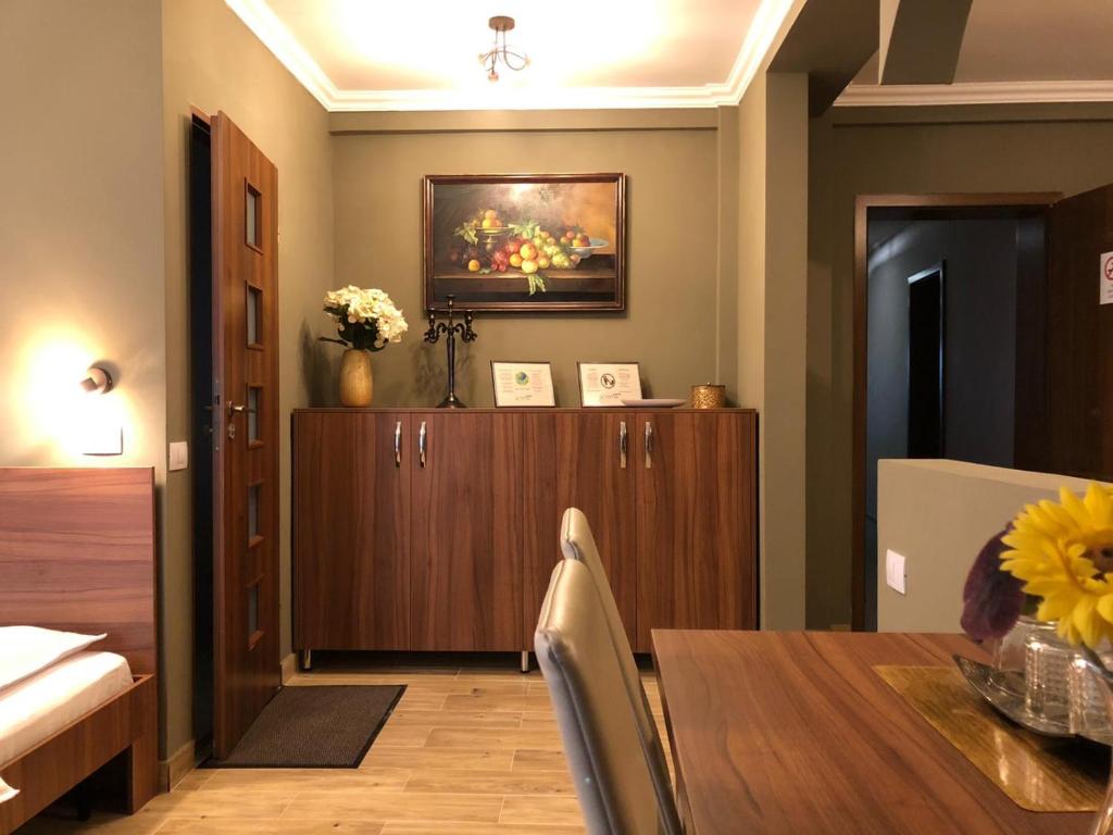 a dining room with a table and a cabinet at Pension Aroma in Baile Felix