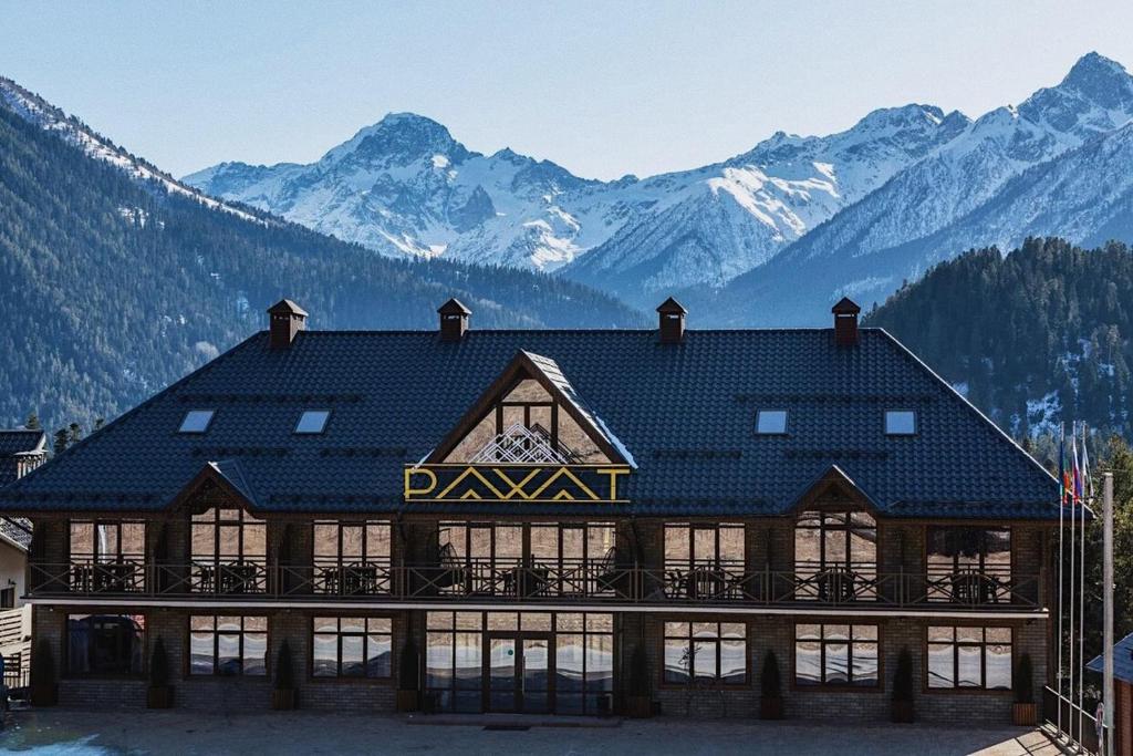 a ski lodge with mountains in the background at Rahat Hotel in Arkhyz