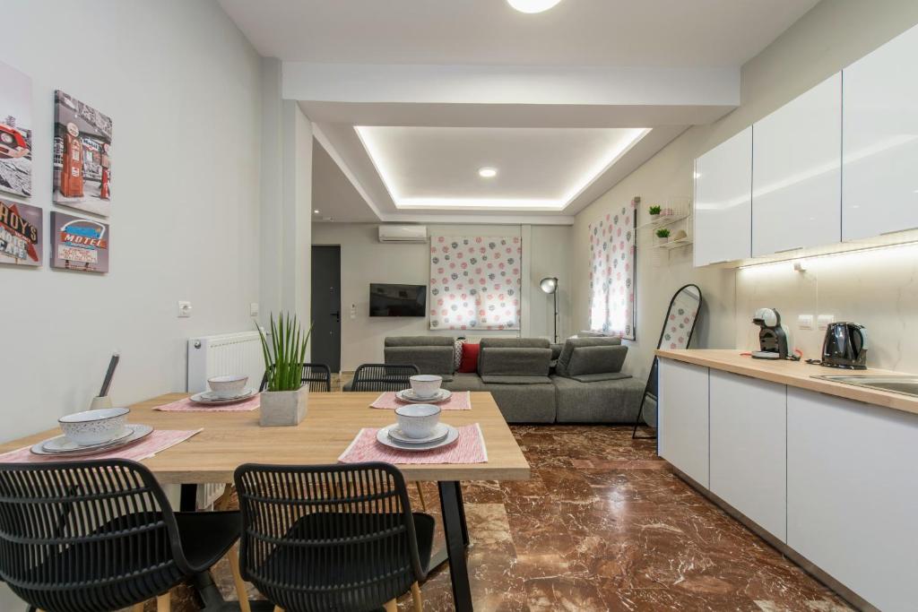 a kitchen and living room with a table and chairs at Bright & Stunning Flat in the City Centre in Zakynthos