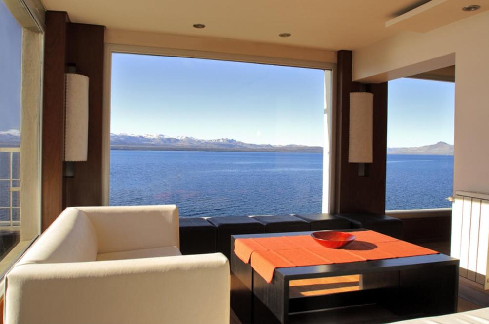 a living room with a large view of the water at Hotel Bariloche Flat in San Carlos de Bariloche