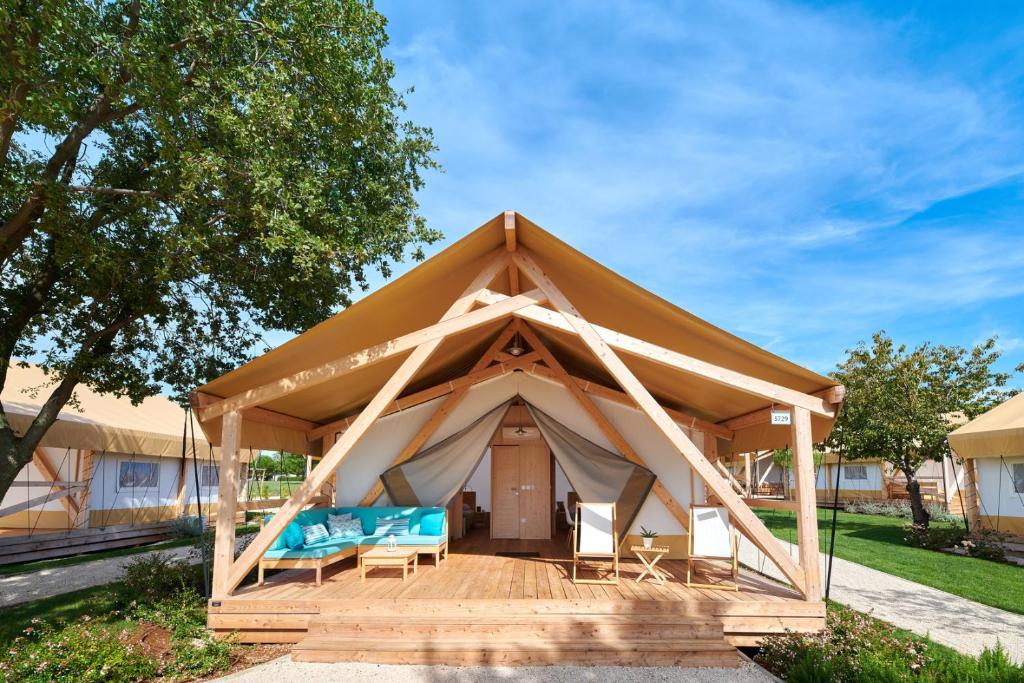 a gazebo with a couch and chairs in it at Camping Park Umag Glamping in Umag