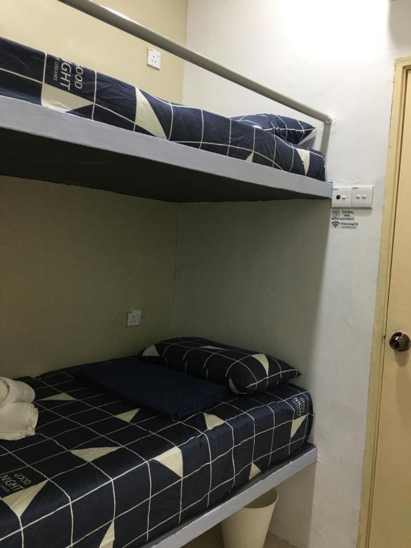 Postel nebo postele na pokoji v ubytování Thian Siong Inn