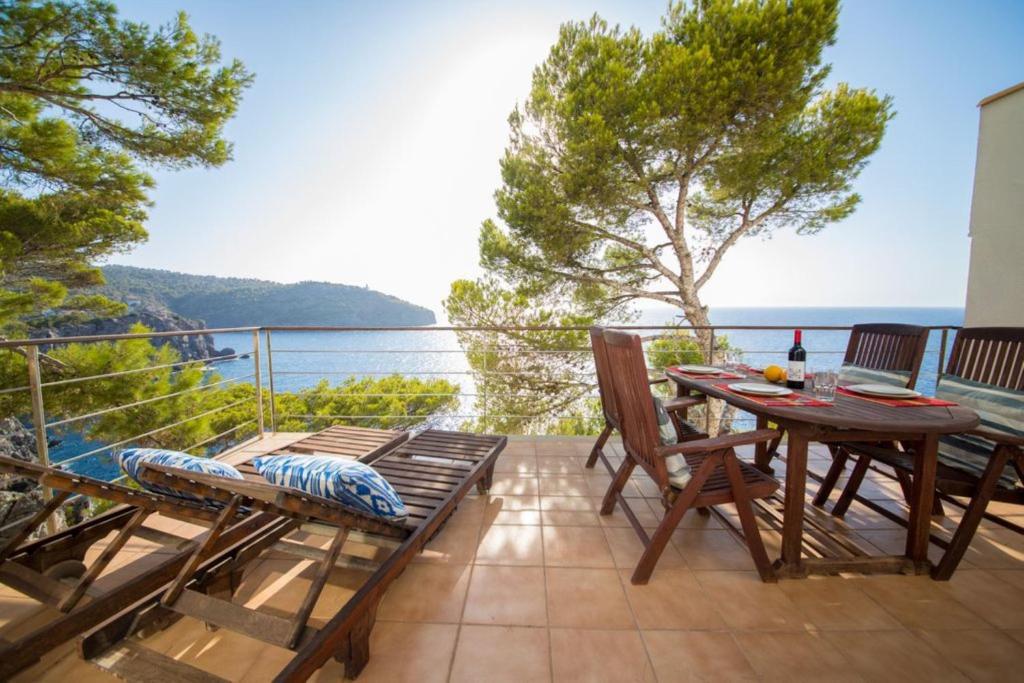 a balcony with a table and chairs and the ocean at Mestral in Port de Soller