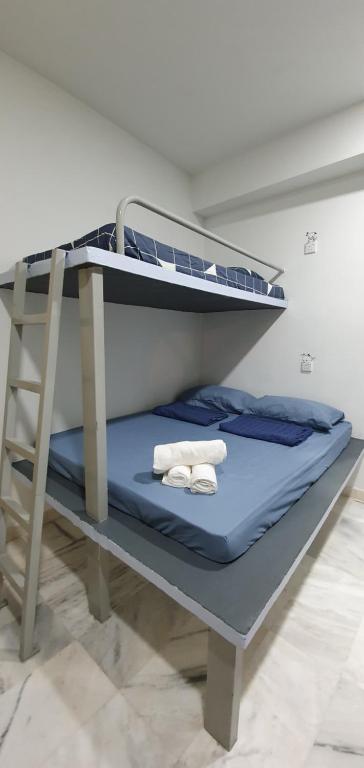 Postel nebo postele na pokoji v ubytování Thian Siong Inn