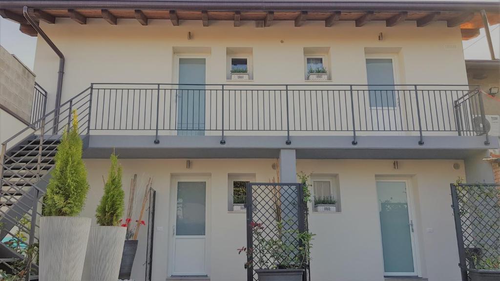 an apartment building with a balcony and a staircase at Maximilian Seven in Aiello del Friuli