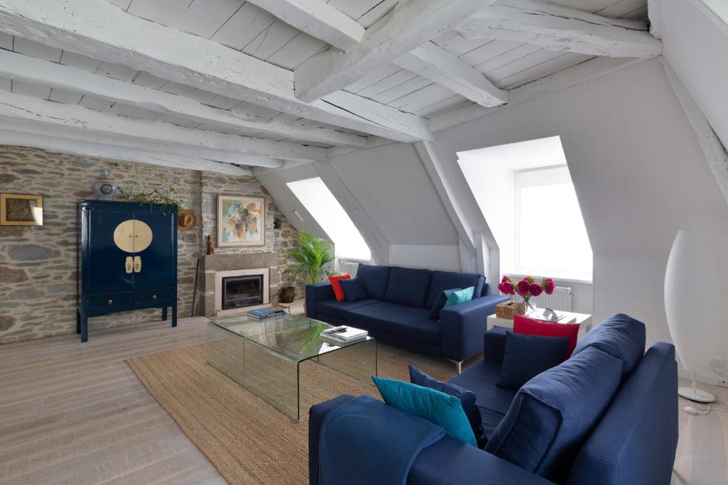 - un salon avec des canapés bleus et une cheminée dans l'établissement Le Marco Polo by Cocoonr, à Saint-Malo