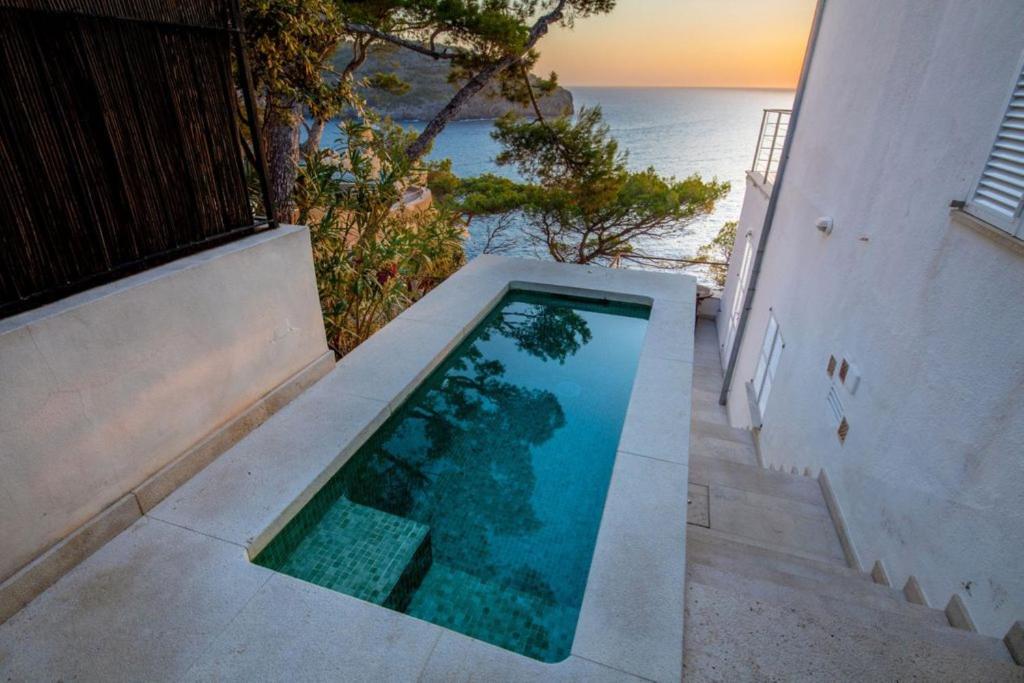 a swimming pool with a view of the ocean at Ponent in Port de Soller