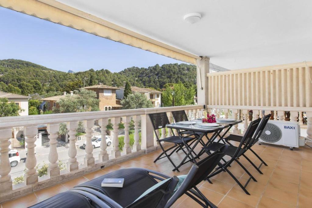 a patio with a table and chairs on a balcony at S Olivera in Port de Soller