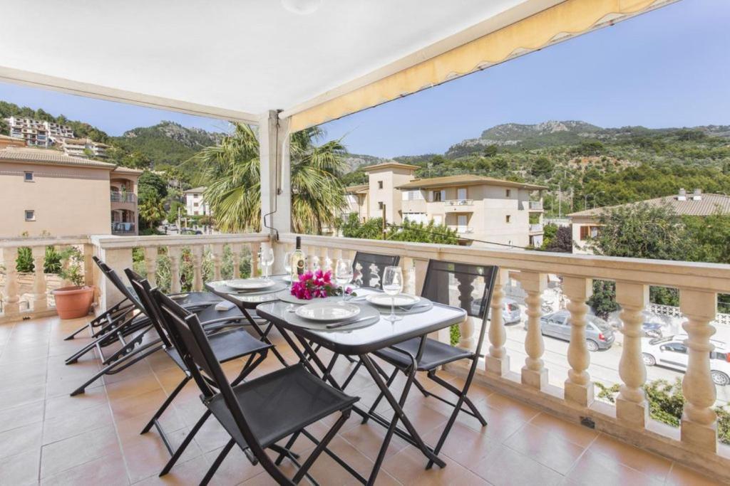 a patio with a table and chairs on a balcony at S Olivera in Port de Soller