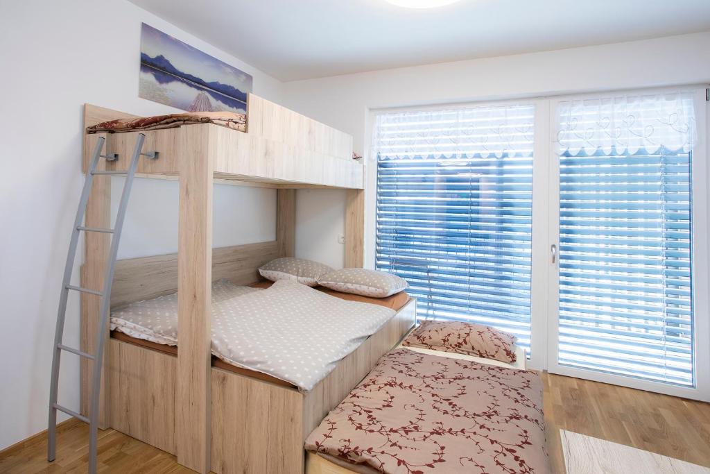 a bedroom with two bunk beds and a window at Studio Novak Bled in Bled
