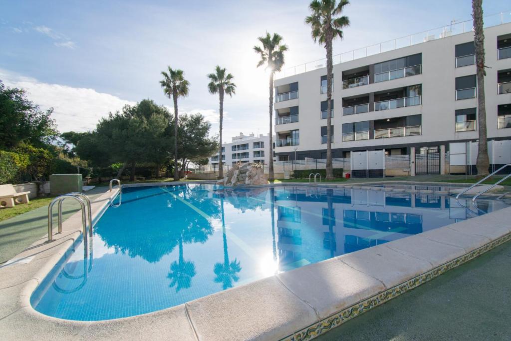 a large swimming pool in front of a building at 58 Luxury Sunny Vacations in La Mata
