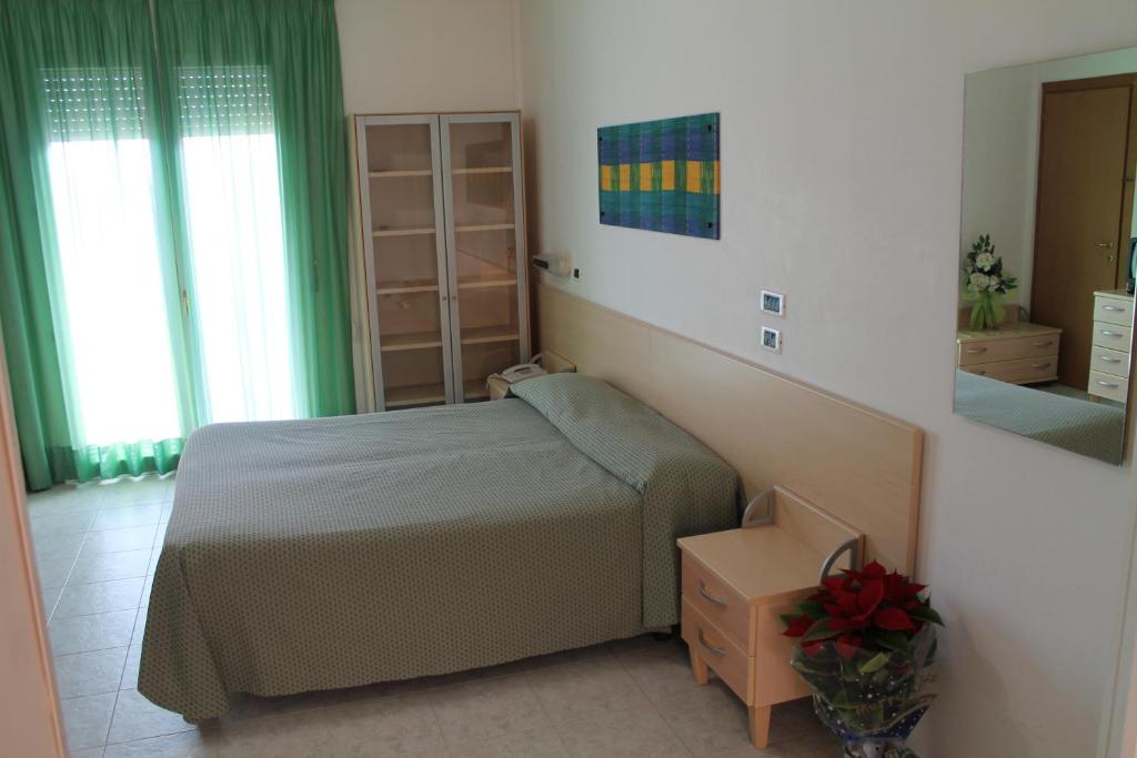 Postel nebo postele na pokoji v ubytování Hotel Minerva