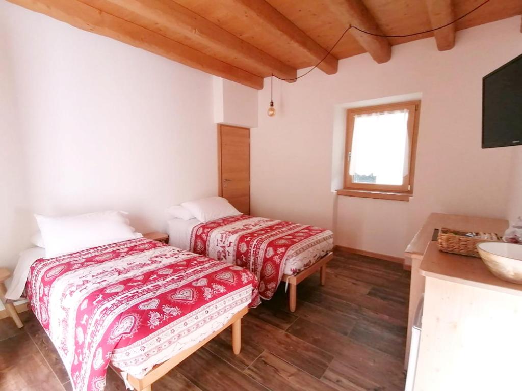 Postel nebo postele na pokoji v ubytování Ai Larici
