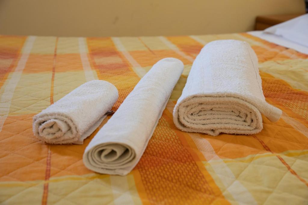 Postel nebo postele na pokoji v ubytování Hotel Merlino
