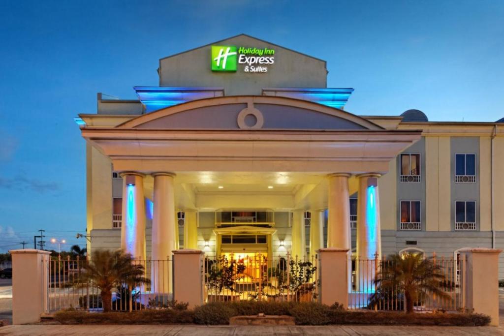 um edifício com um sinal em cima em Holiday Inn Express Trincity, an IHG Hotel em Piarco