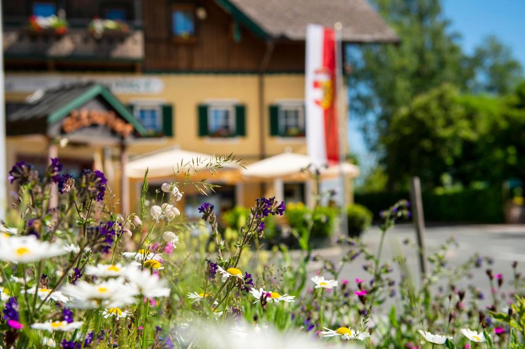 um campo de flores em frente a um edifício em Hotel Landgasthof Altwirt em Seeham