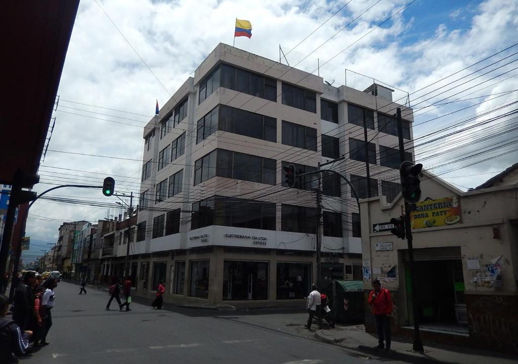a tall building with a flag on top of it at La Merced Plaza Hostal in Riobamba