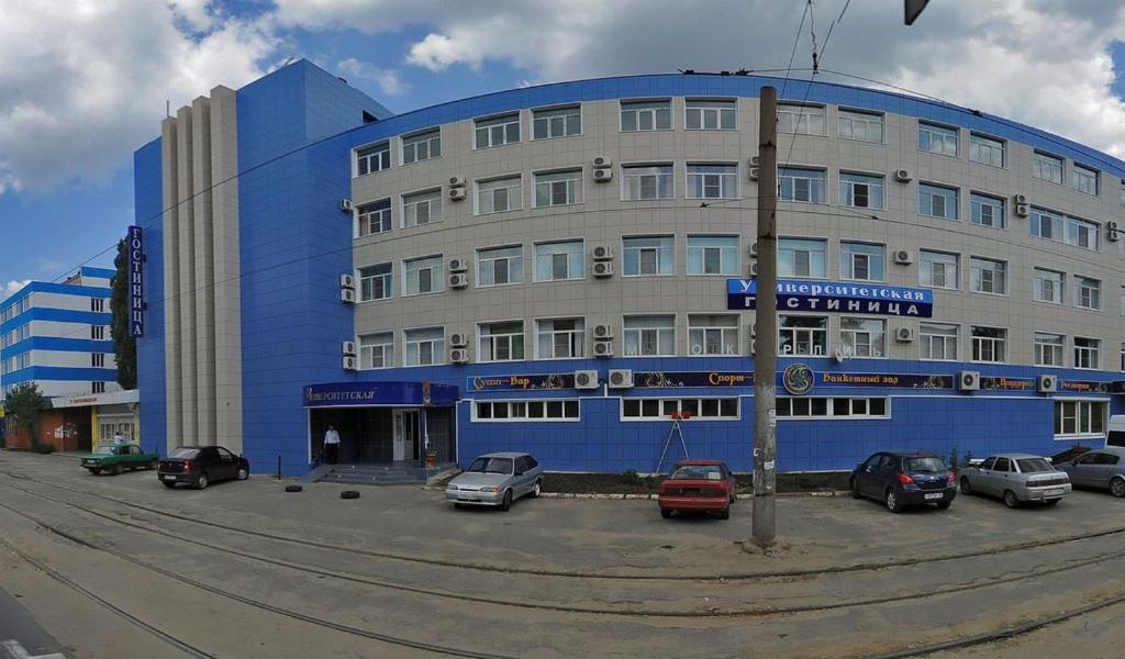 un edificio azul con coches estacionados frente a él en Universitetskaya, en Lipetsk